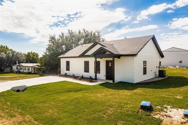 a view of a house with pool and chairs