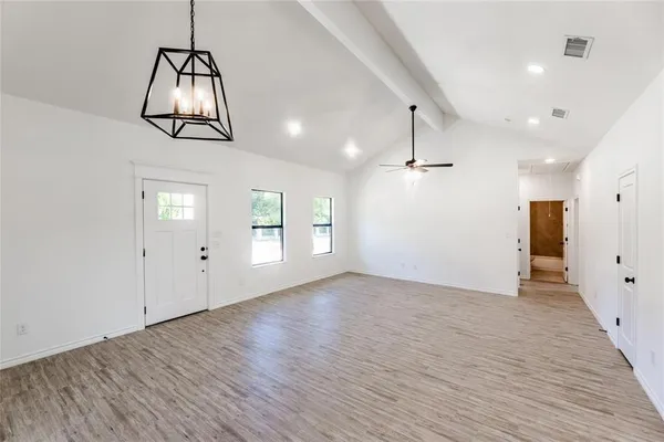 a view of kitchen with stainless steel appliances granite countertop cabinets and wooden floor