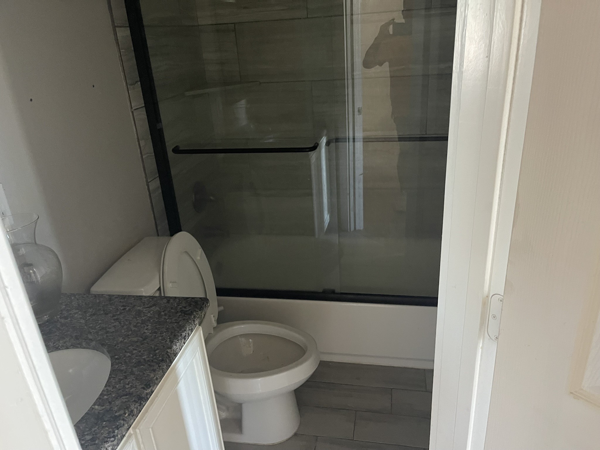 5829 Hartwick Road Houston, TX 77016 - Photo 15 of 47 a bathroom with a granite countertop sink and a toilet