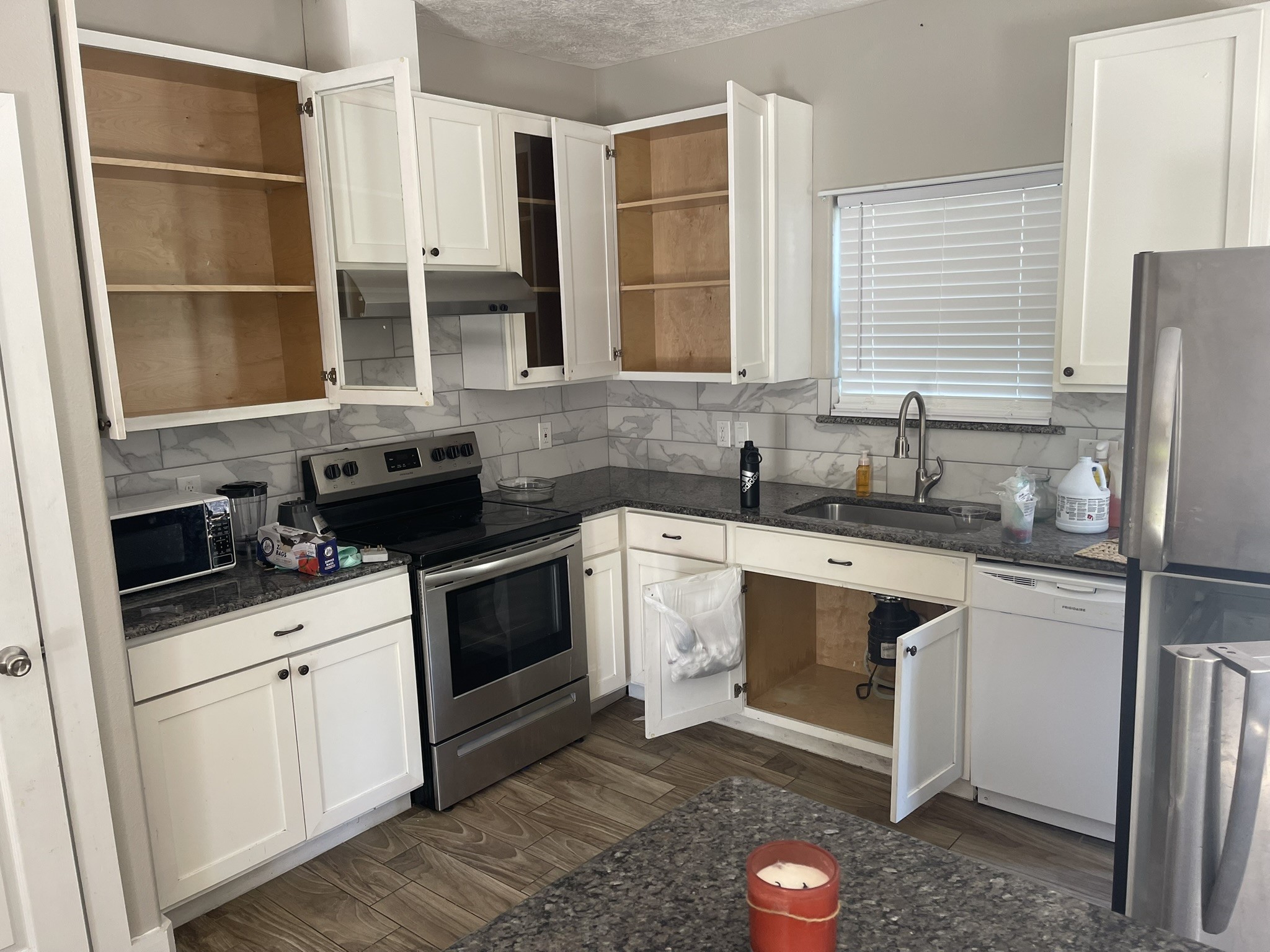 5829 Hartwick Road Houston, TX 77016 - Photo 21 of 47 a kitchen with granite countertop a sink stainless steel appliances and cabinets