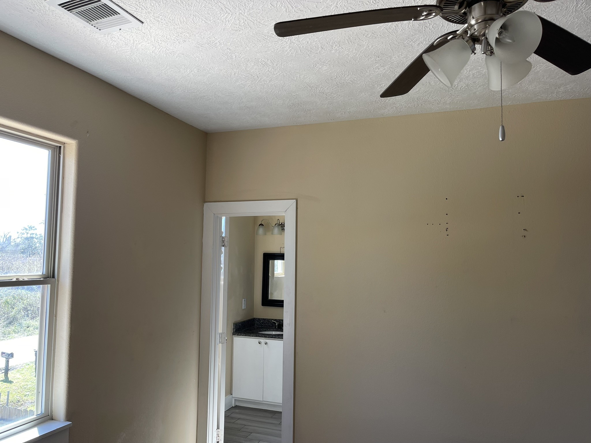5829 Hartwick Road Houston, TX 77016 - Photo 25 of 47 a view of hallway with a large window and a ceiling fan