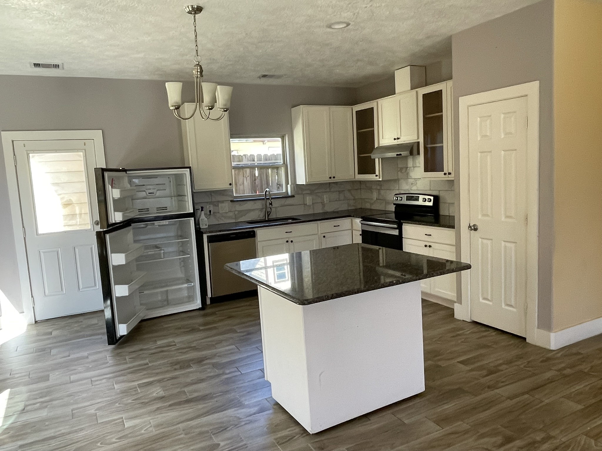 5829 Hartwick Road Houston, TX 77016 - Photo 8 of 47 a kitchen with stainless steel appliances granite countertop a sink stove and wooden floor