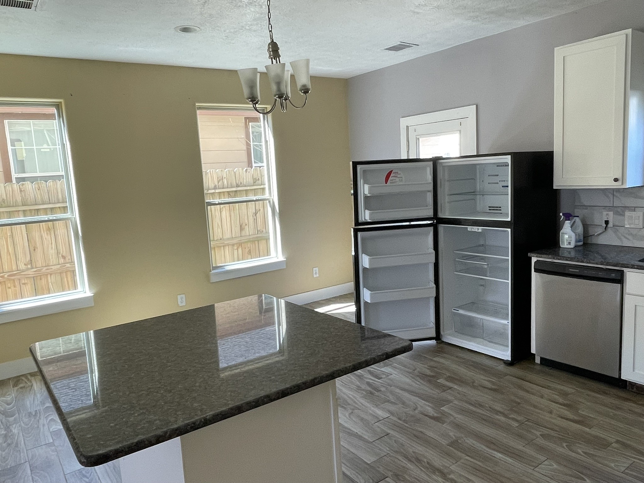 5829 Hartwick Road Houston, TX 77016 - Photo 9 of 47 a kitchen with granite countertop a refrigerator and a sink