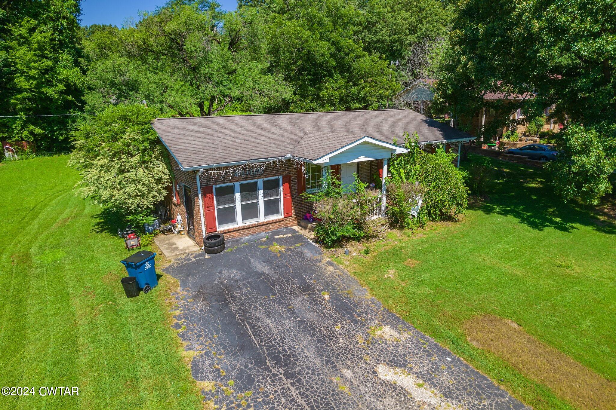 119 Robertson Avenue Camden, TN 38320 - Photo 1 of 28 a view of a house with garden