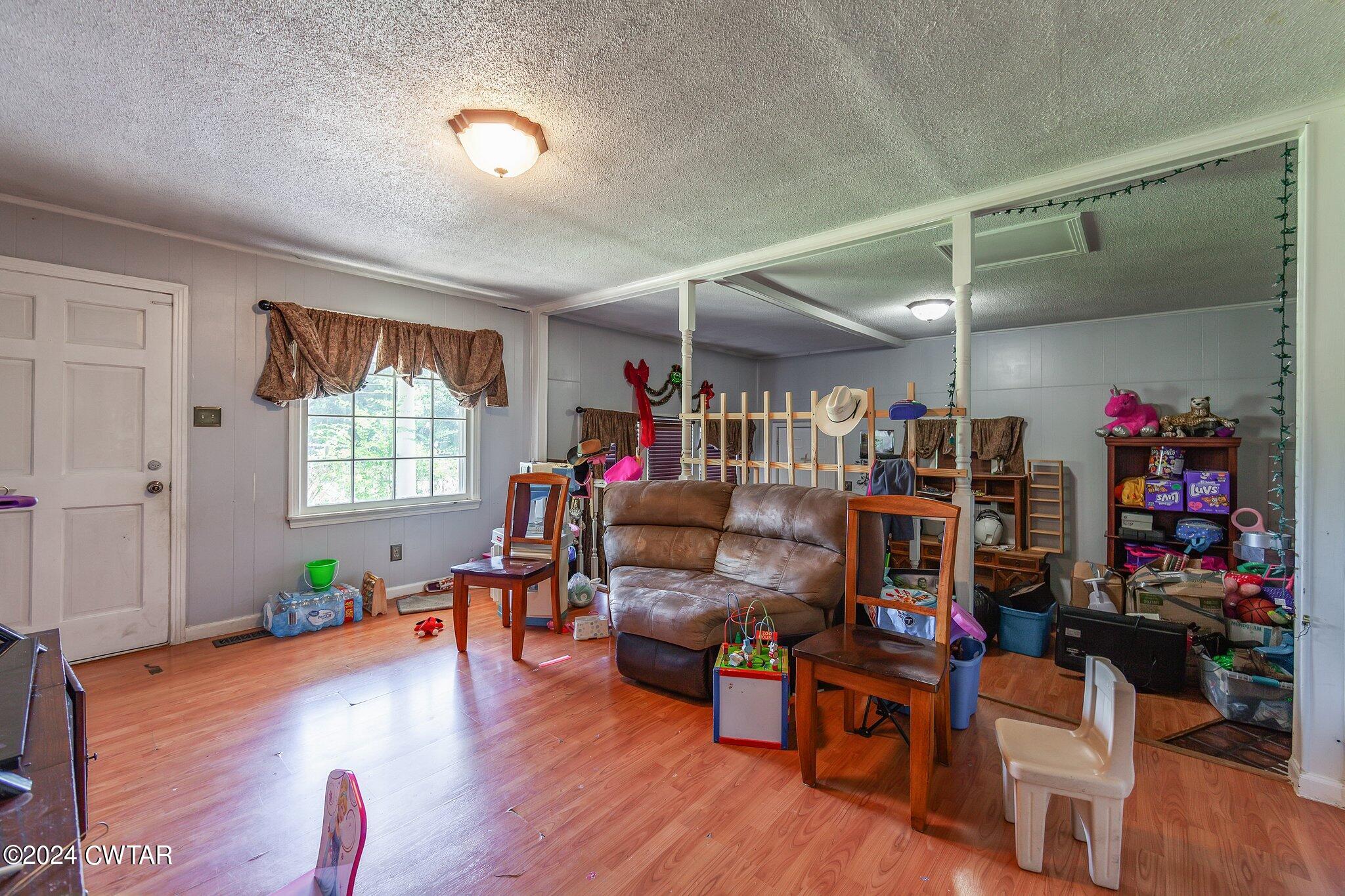 119 Robertson Avenue Camden, TN 38320 - Photo 16 of 28 a room with furniture and a wooden floor