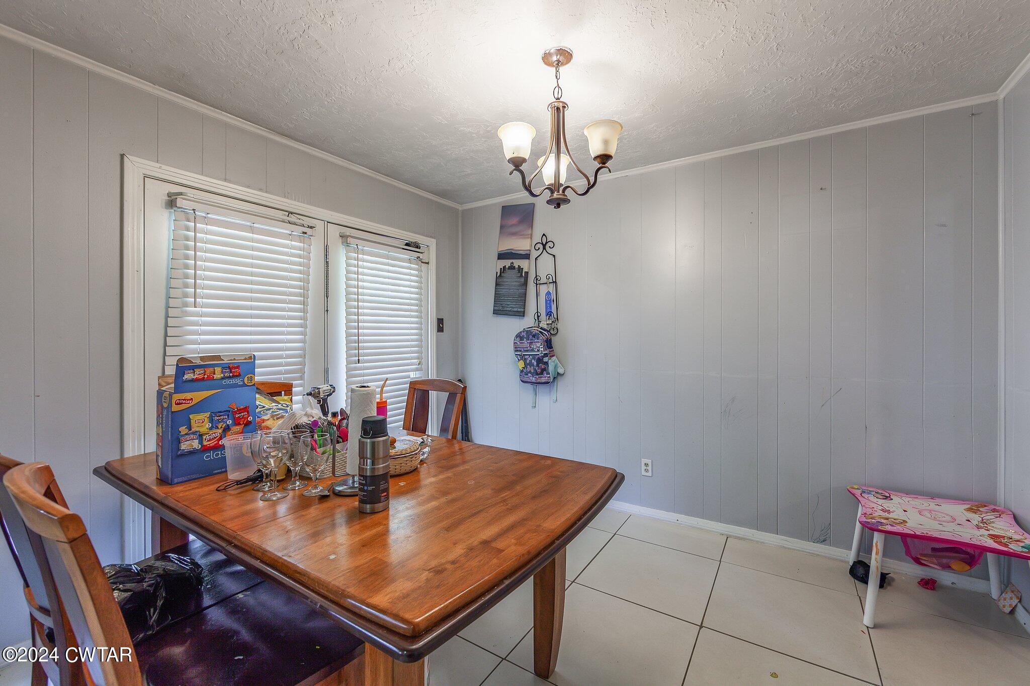 119 Robertson Avenue Camden, TN 38320 - Photo 20 of 28 a view of a dining room with furniture and window