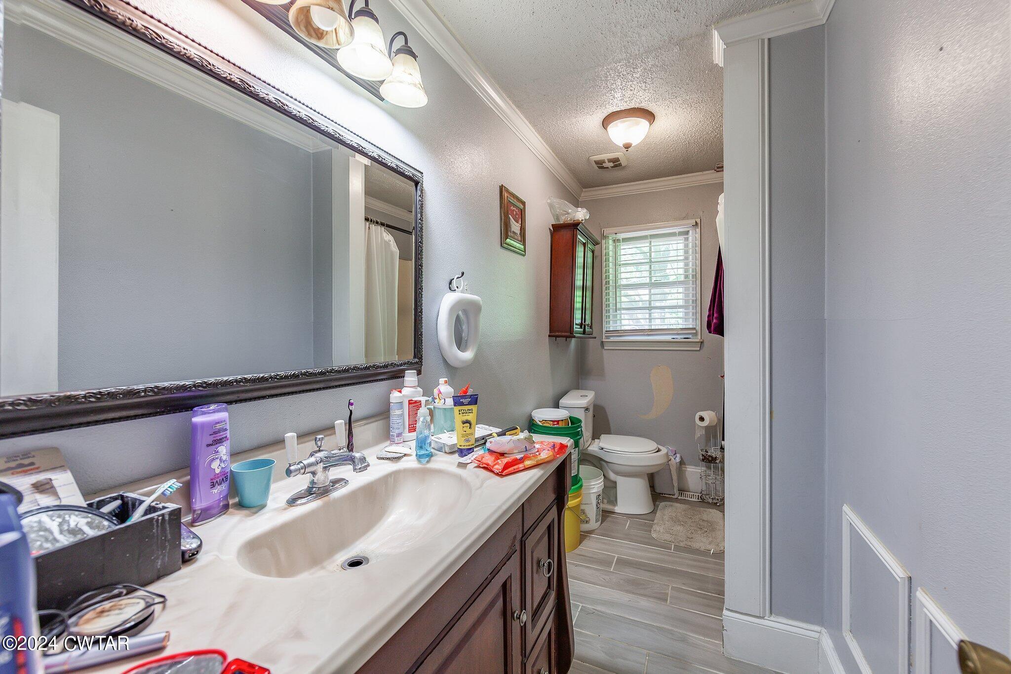 119 Robertson Avenue Camden, TN 38320 - Photo 24 of 28 a bathroom with a sink vanity and a mirror