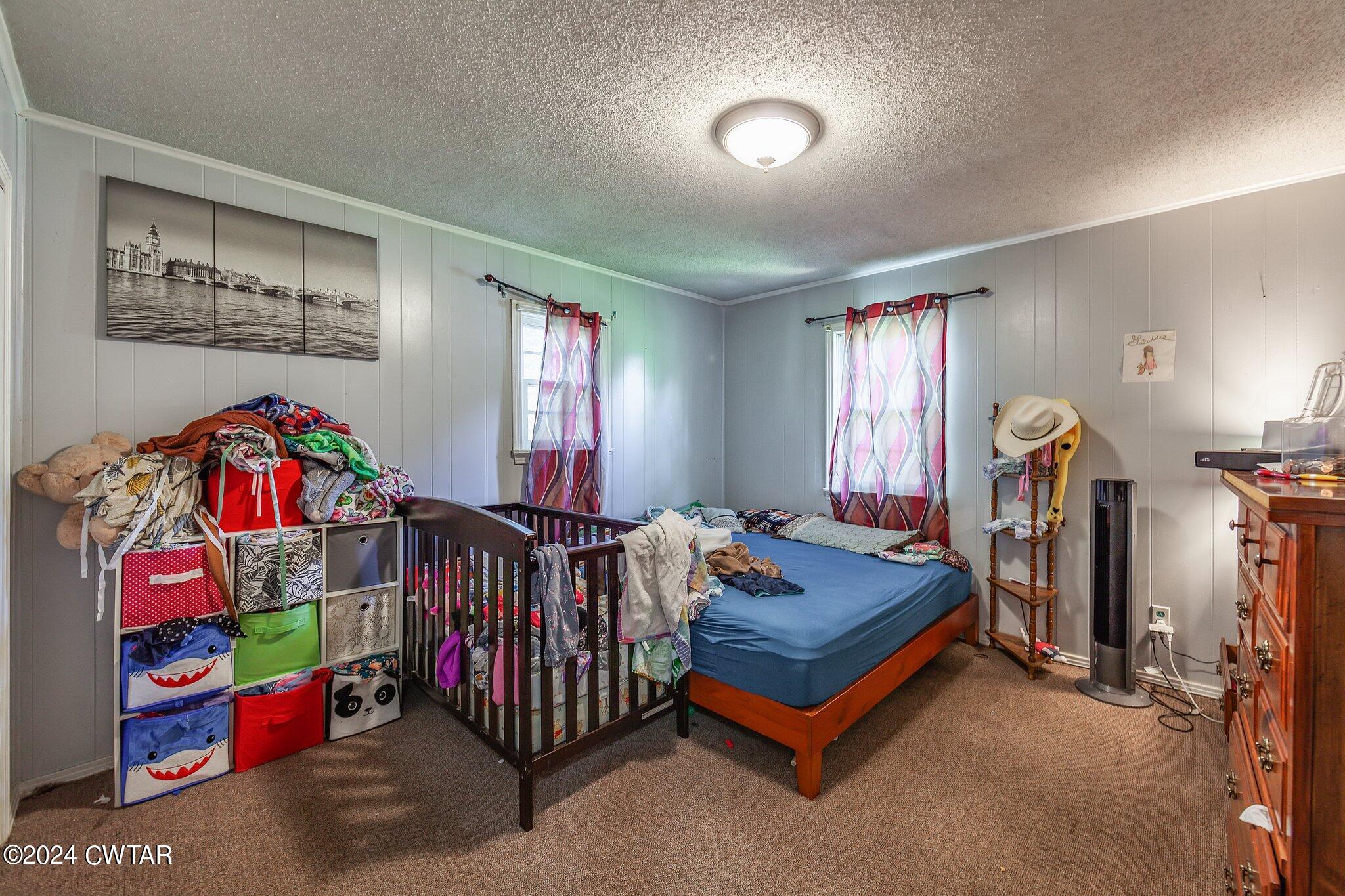 119 Robertson Avenue Camden, TN 38320 - Photo 25 of 28 a bed room with furniture and a window