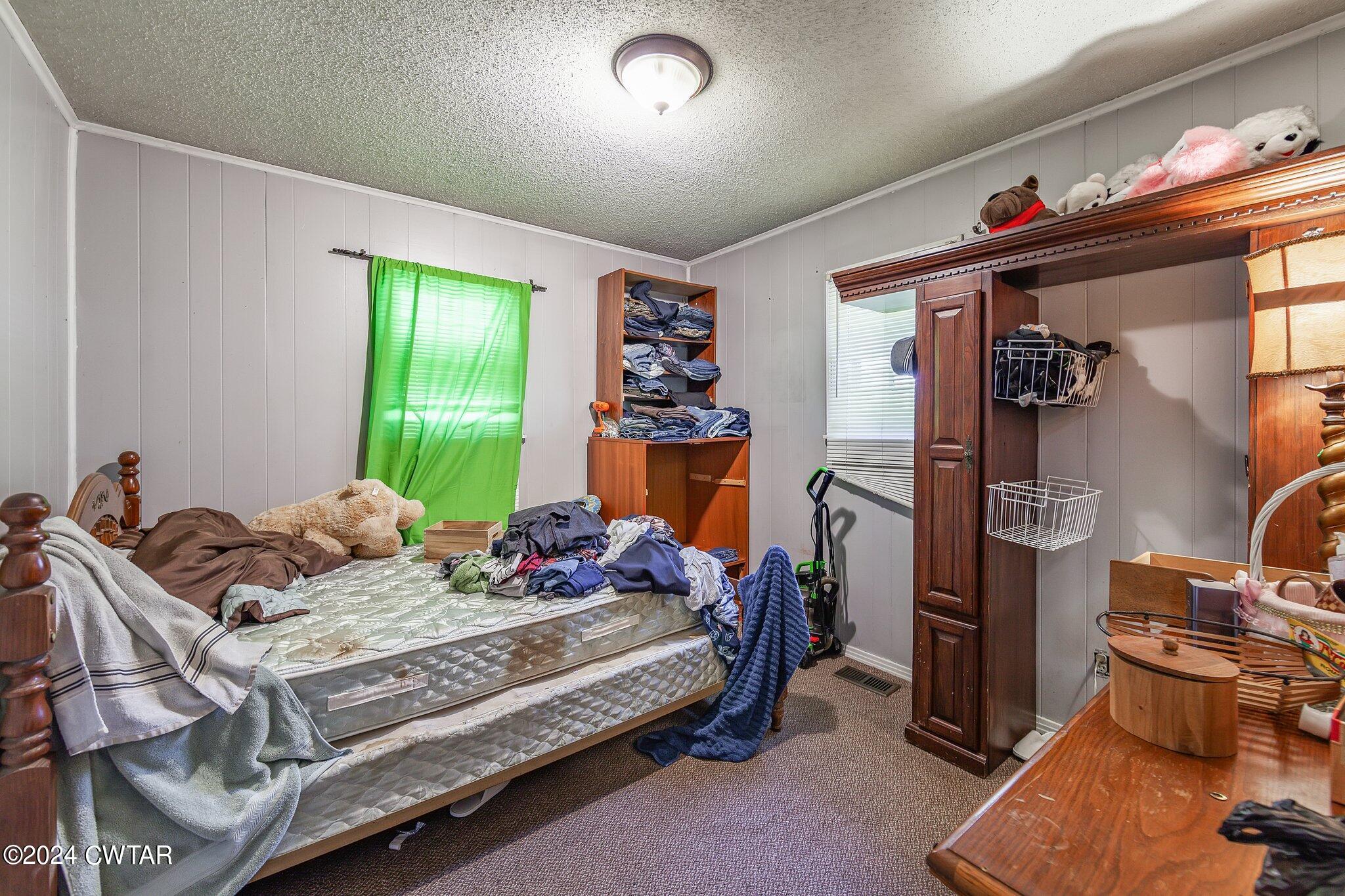 119 Robertson Avenue Camden, TN 38320 - Photo 26 of 28 a bedroom with bed and a view of living room