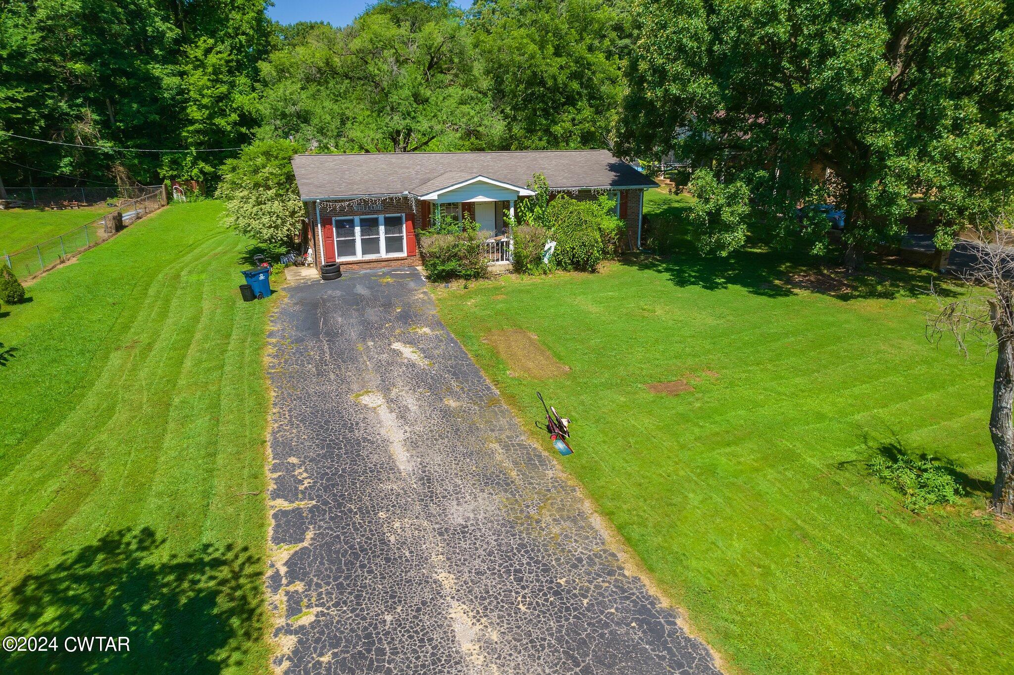 119 Robertson Avenue Camden, TN 38320 - Photo 3 of 28 a front view of a house with yard