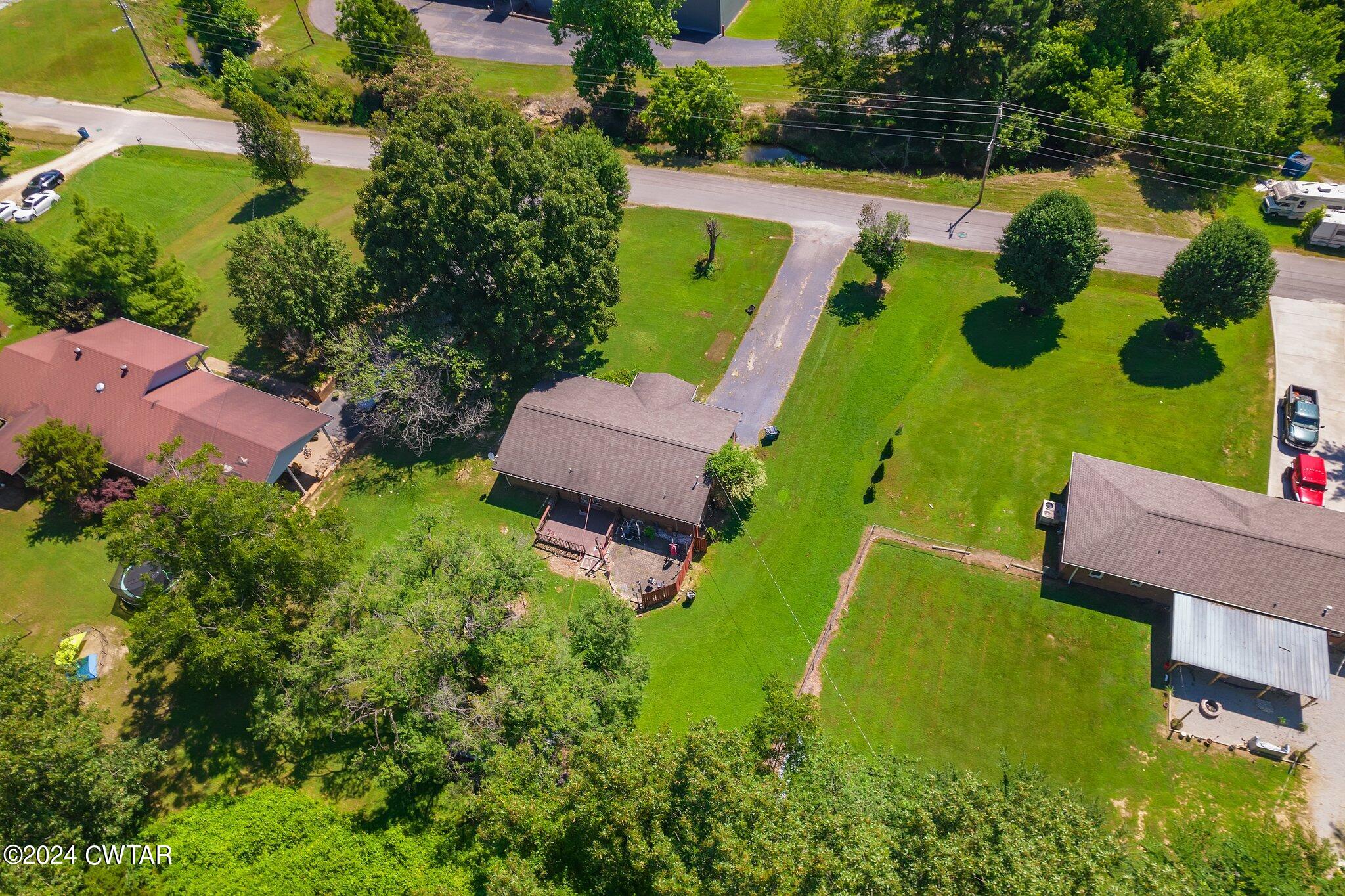 119 Robertson Avenue Camden, TN 38320 - Photo 5 of 28 an aerial view of a house with yard swimming pool and outdoor seating
