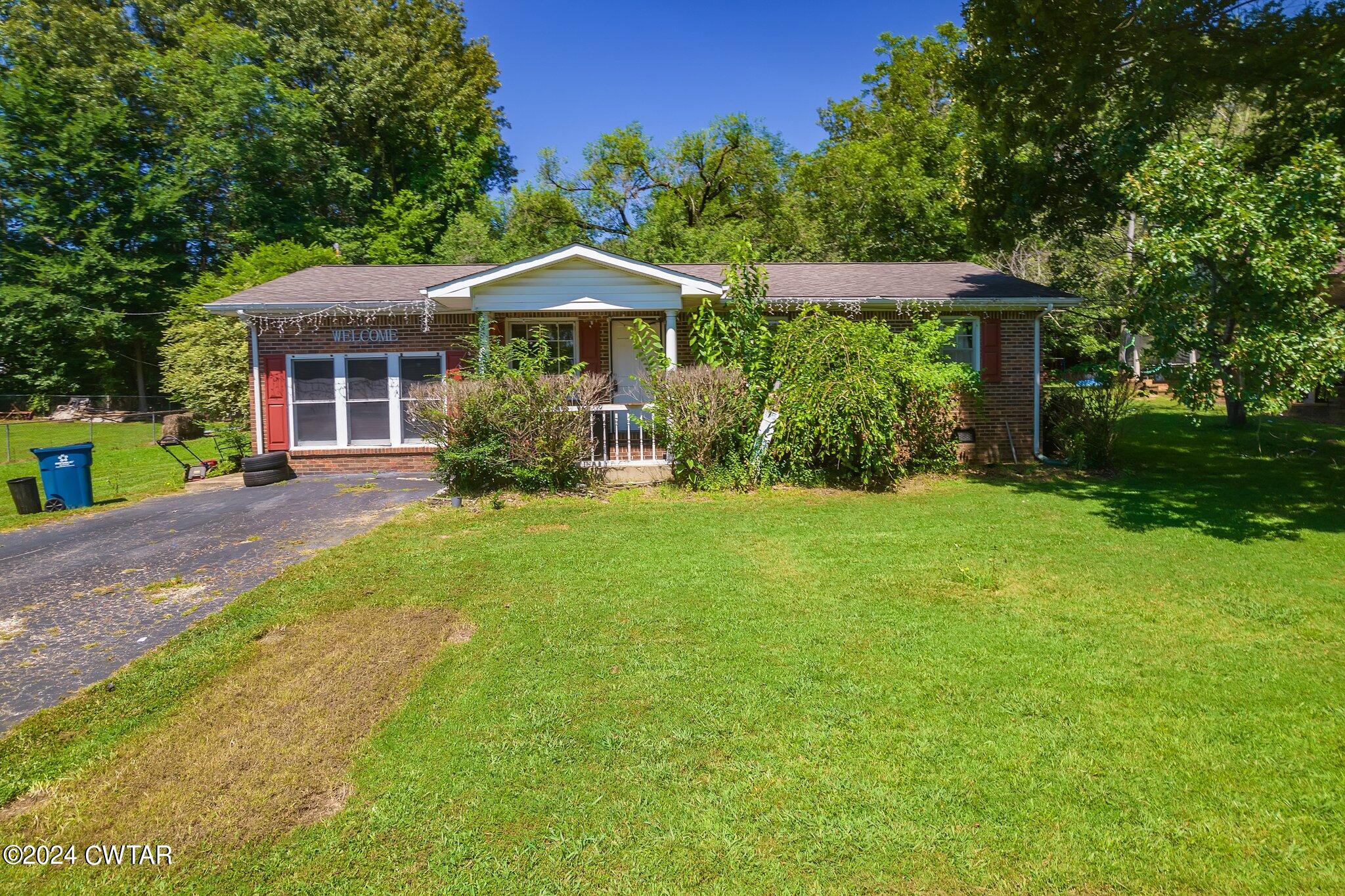 119 Robertson Avenue Camden, TN 38320 - Photo 6 of 28 a front view of house with yard and green space