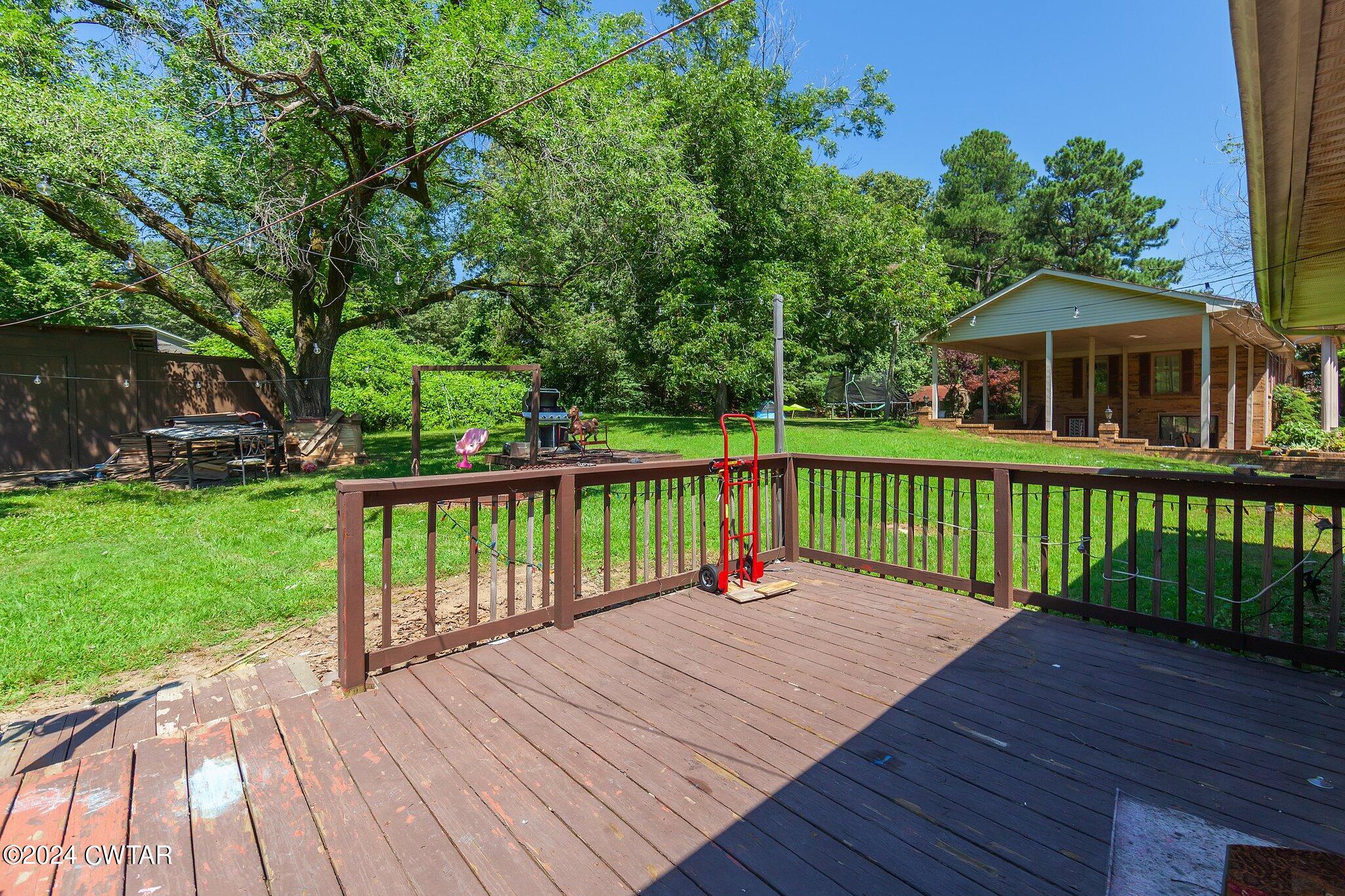119 Robertson Avenue Camden, TN 38320 - Photo 9 of 28 a view of a deck and a yard with wooden fence