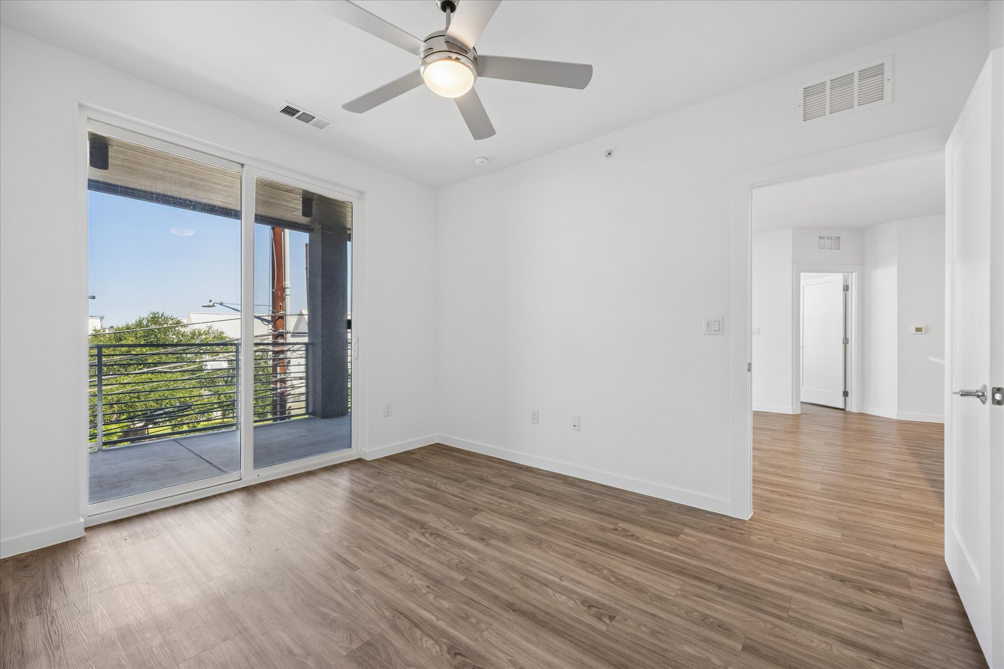 4801 Springdale Road, Unit 2210 Austin, TX 78723 - Photo 4 of 14 The primary bedroom allows plenty of light and has access to the balcony