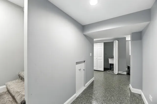 a view of a hallway with closet and wooden floor