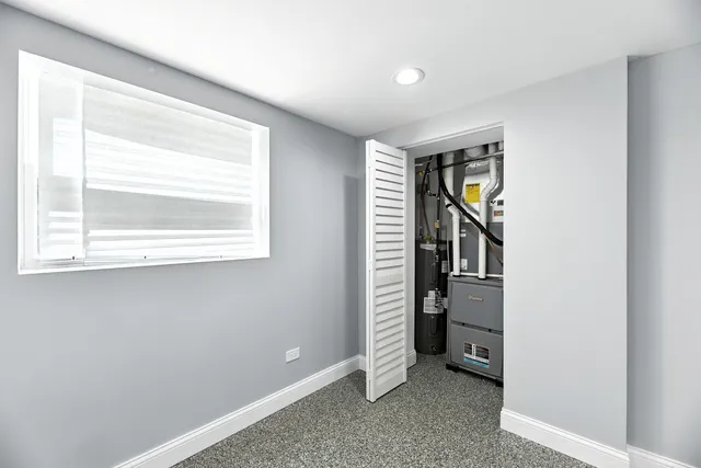 a view of an empty room with window and stairs