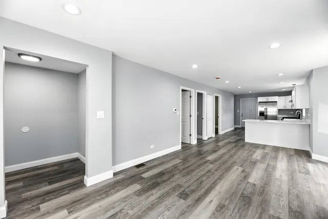a view of kitchen with wooden floor and electronic appliances