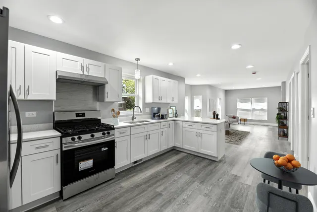 a kitchen with a stove and white cabinets