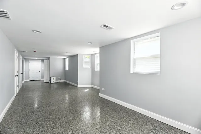 a view of a livingroom with wooden floor and a window