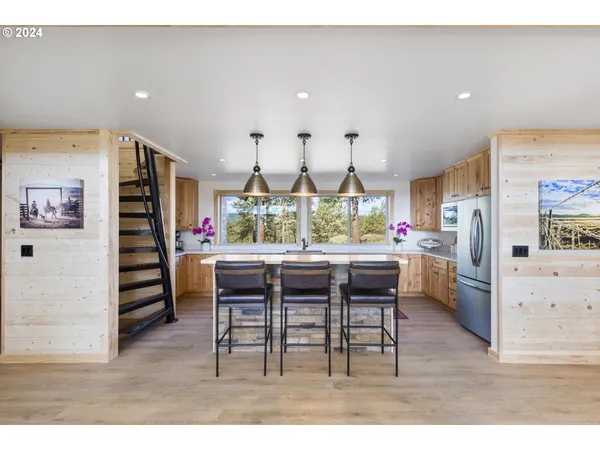 a kitchen with stainless steel appliances kitchen island granite countertop a stove a sink and a microwave
