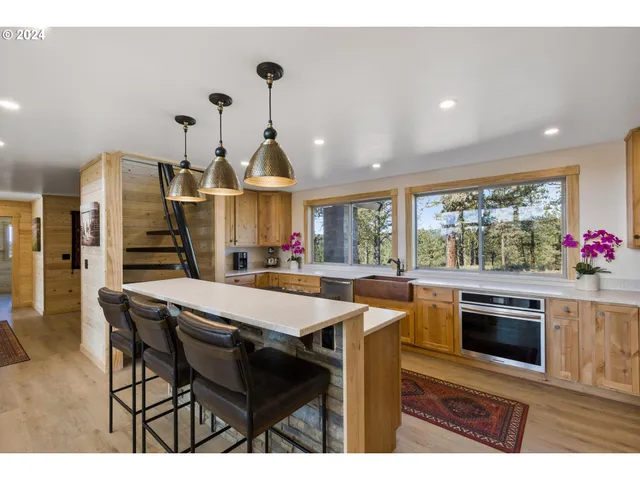 a kitchen with sink refrigerator and large window