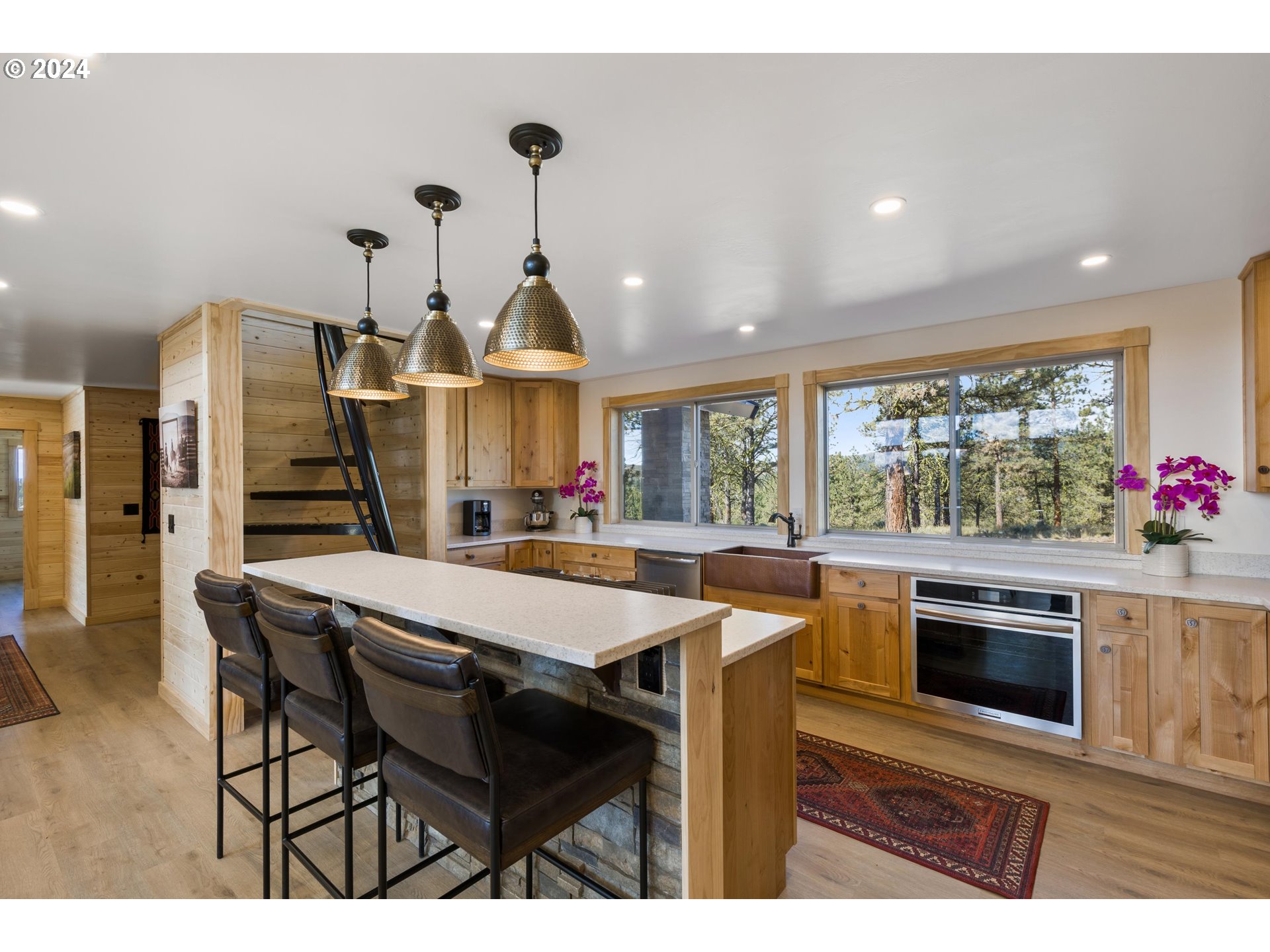 45371 Hackmore Drive Seneca, OR 97873 - Photo 13 of 37 a kitchen with stainless steel appliances kitchen island granite countertop a stove a sink and a microwave