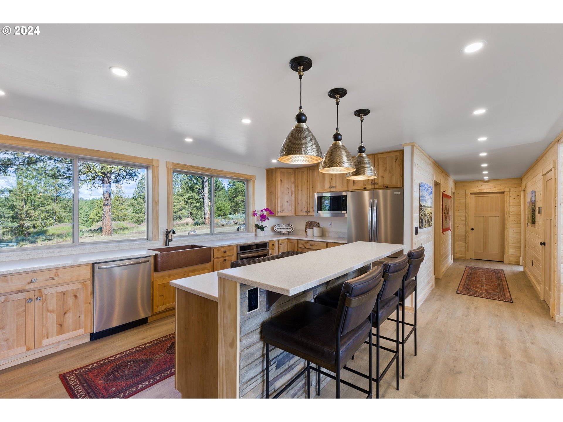 45371 Hackmore Drive Seneca, OR 97873 - Photo 15 of 37 a kitchen with stainless steel appliances granite countertop a kitchen island a stove a table and a refrigerator