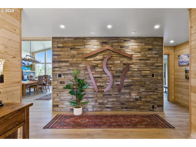 a living room with furniture a ceiling fan and a wooden floor
