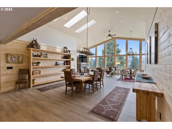 a living room with furniture a wooden floor and next to a window