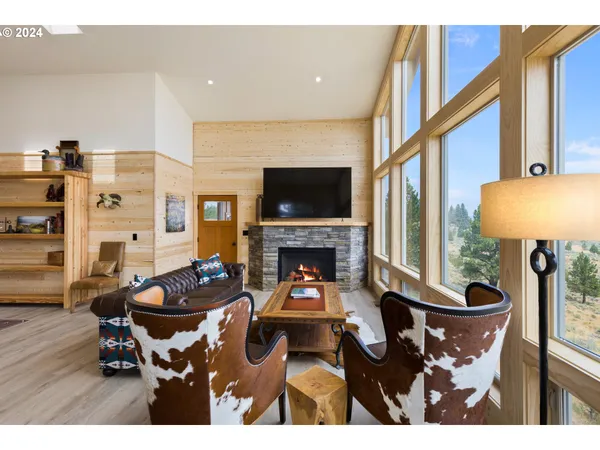 a dining room with furniture a chandelier and wooden floor