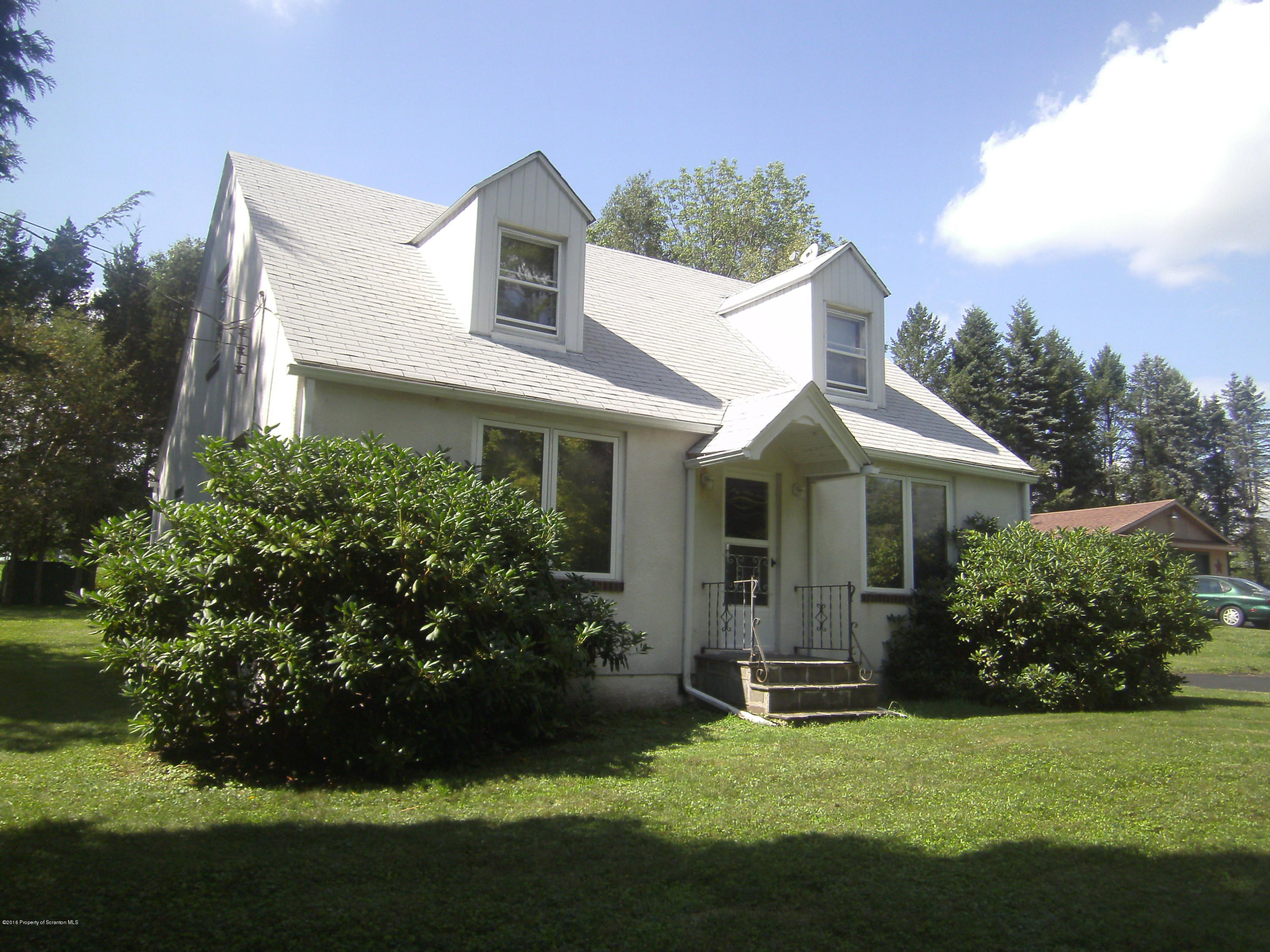 855 Becks Crossing Road Moscow, PA 18444 - Photo 1 of 43 a front view of a house with a garden and yard