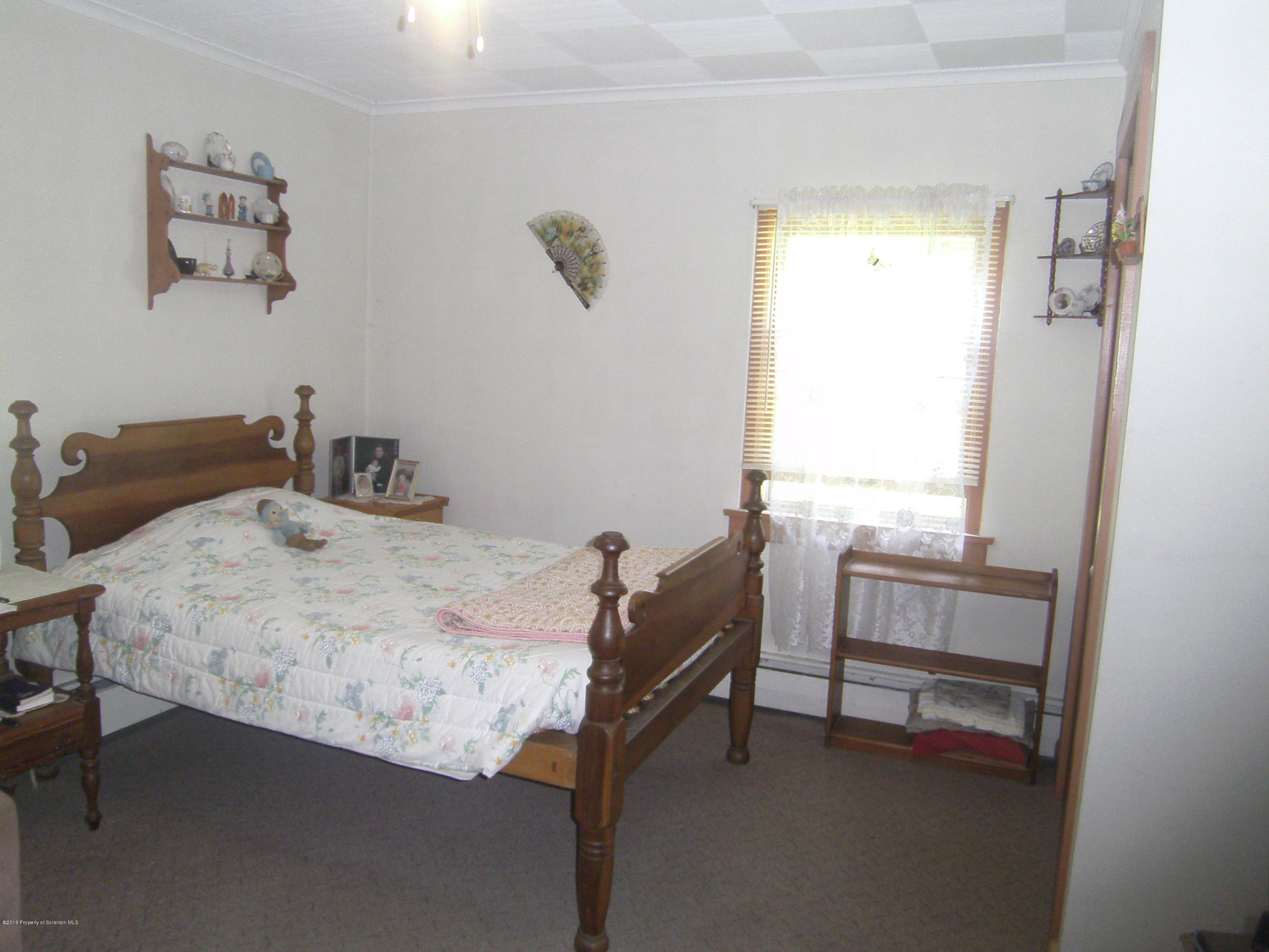 855 Becks Crossing Road Moscow, PA 18444 - Photo 12 of 43 a bedroom with a bed and a window