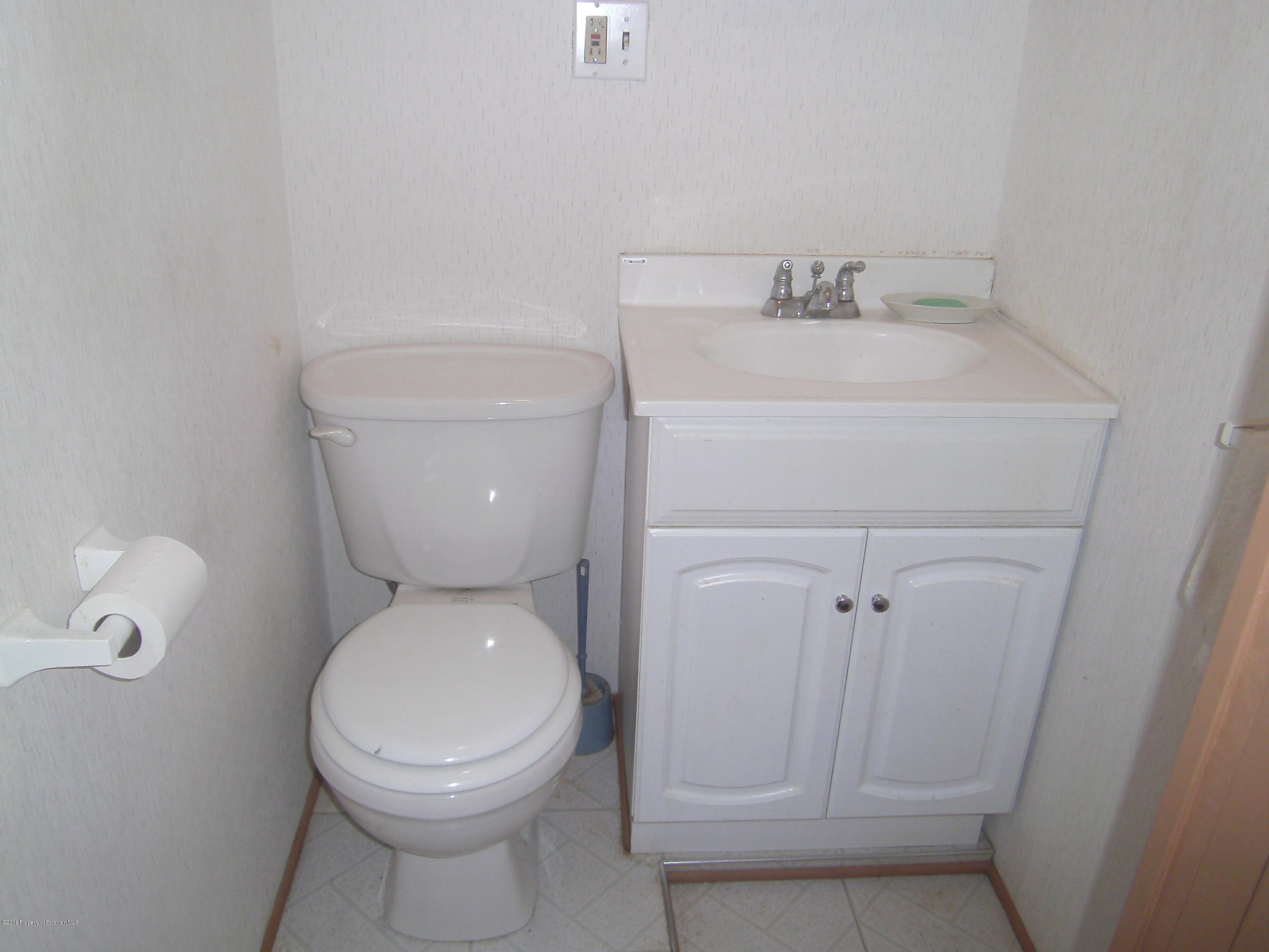 855 Becks Crossing Road Moscow, PA 18444 - Photo 18 of 43 a white toilet sitting next to a bathroom sink
