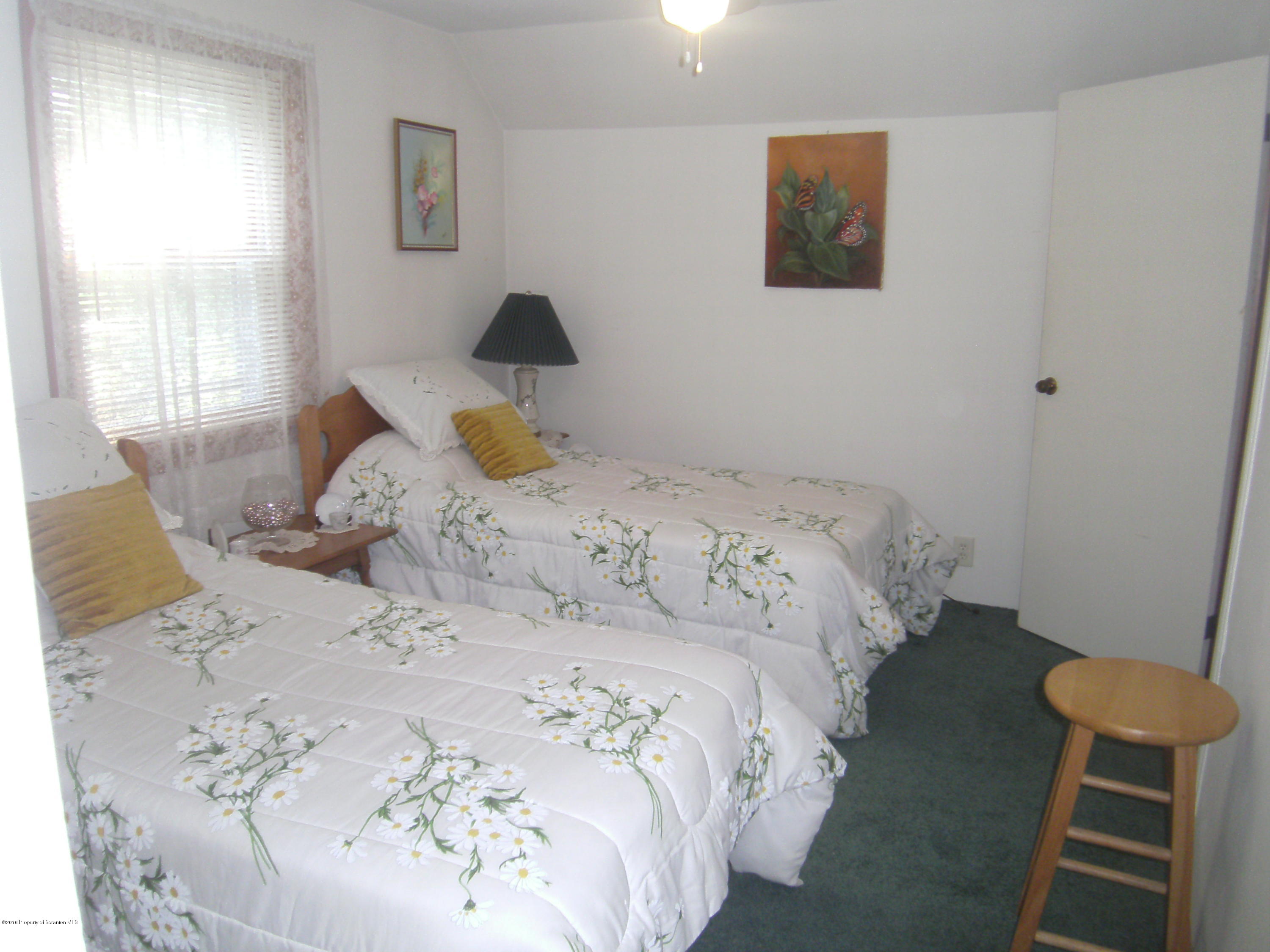 855 Becks Crossing Road Moscow, PA 18444 - Photo 21 of 43 a bedroom with a bed and a window