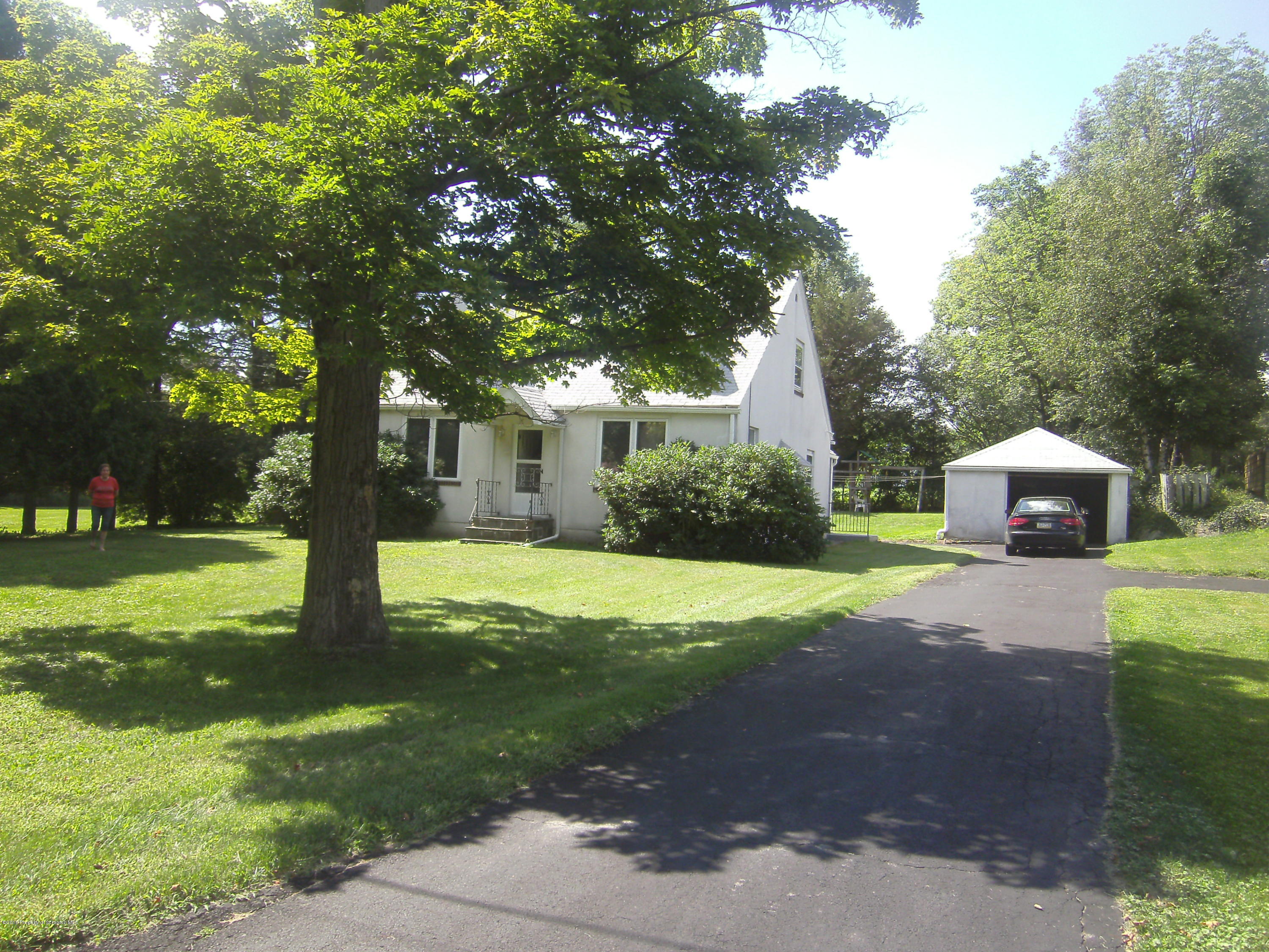 855 Becks Crossing Road Moscow, PA 18444 - Photo 36 of 43 a yellow house with trees in front of it