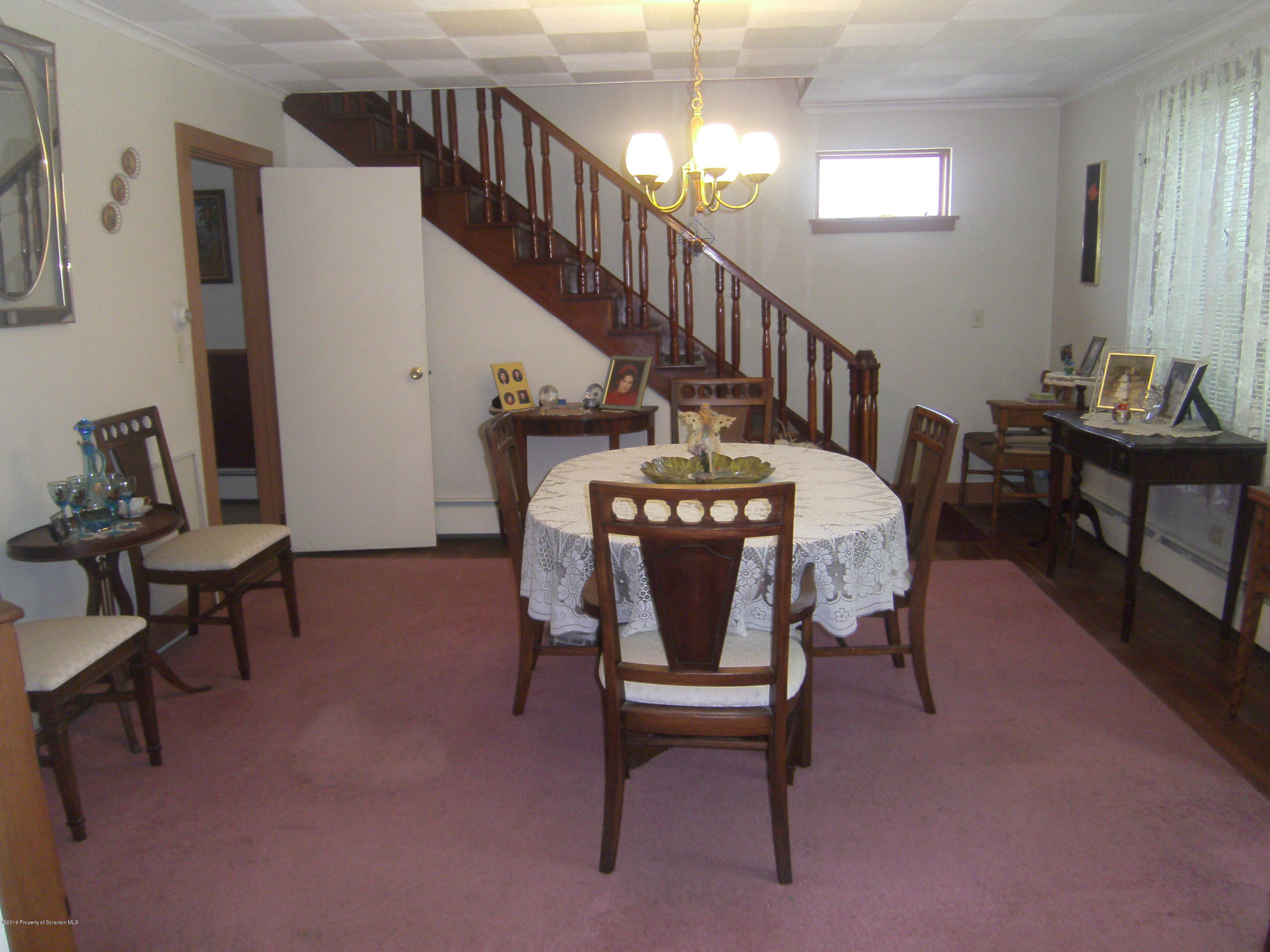 855 Becks Crossing Road Moscow, PA 18444 - Photo 4 of 43 a living room with furniture and a dining table