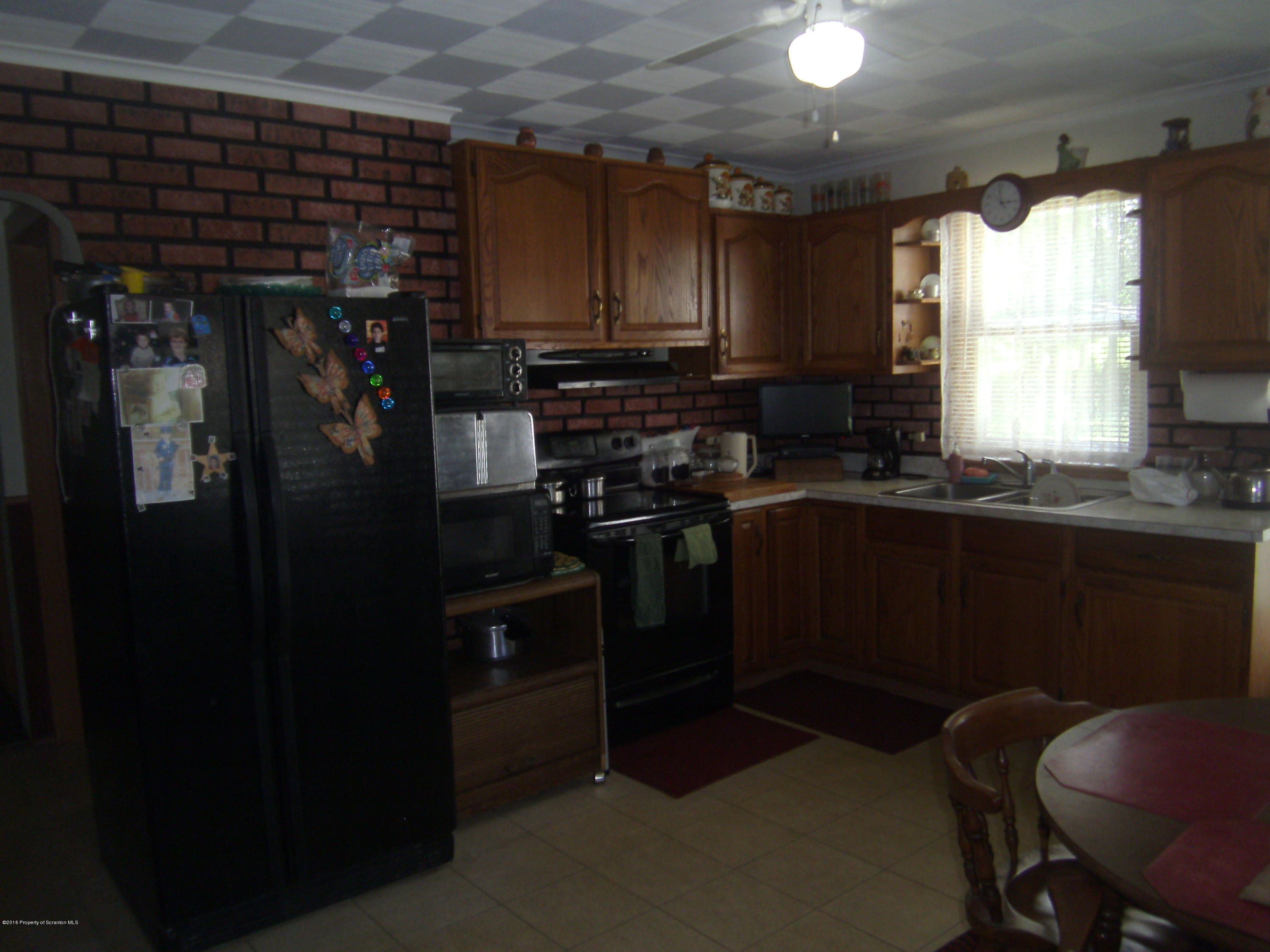 855 Becks Crossing Road Moscow, PA 18444 - Photo 42 of 43 a kitchen with a sink appliances and cabinets