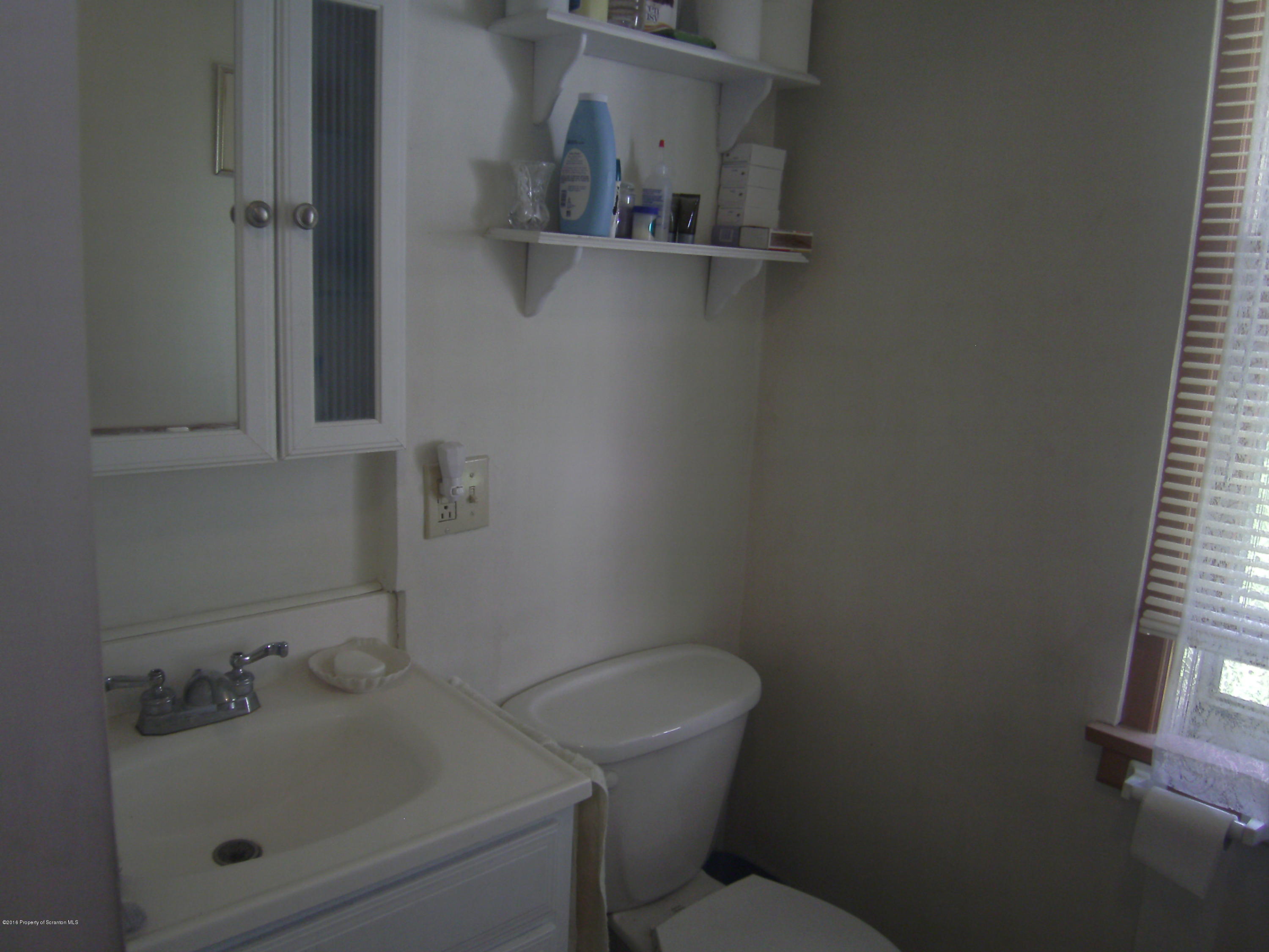 855 Becks Crossing Road Moscow, PA 18444 - Photo 9 of 43 a bathroom with a sink toilet and vanity