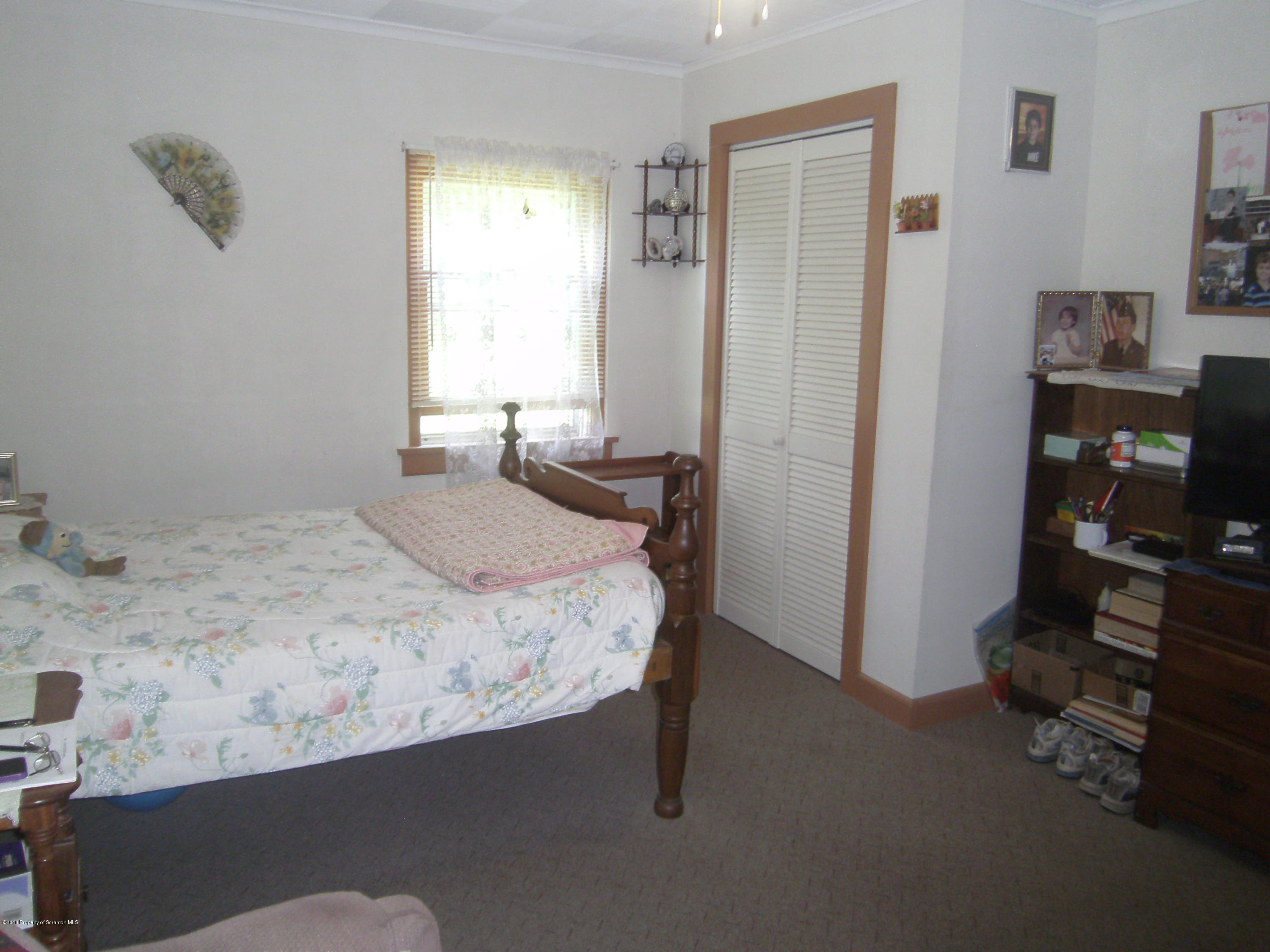 855 Becks Crossing Road Moscow, PA 18444 - Photo 10 of 43 a bedroom with a bed and a window