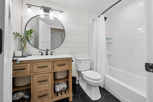 a bathroom with a toilet sink and a mirror