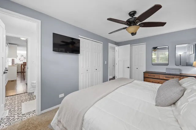 a bedroom with a large bed and a flat screen tv