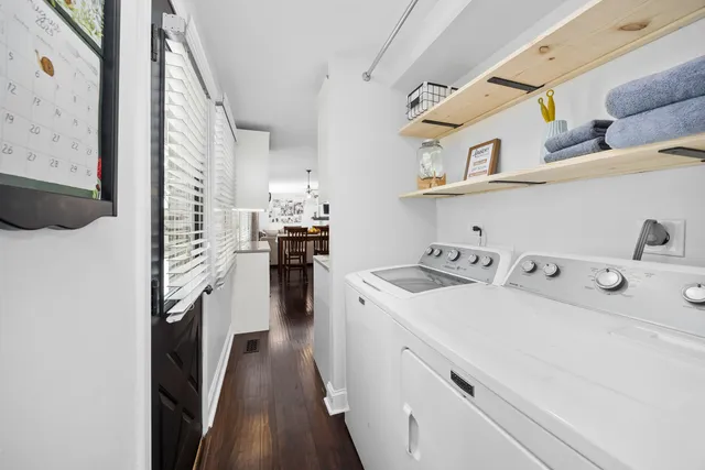 a view of washer and dryer with kitchen in the background