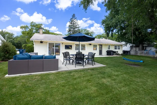 a patio with table and chairs