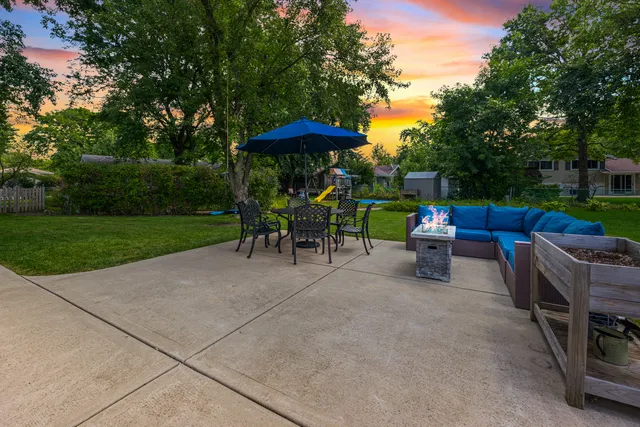 a view of backyard with outdoor seating a patio and plants