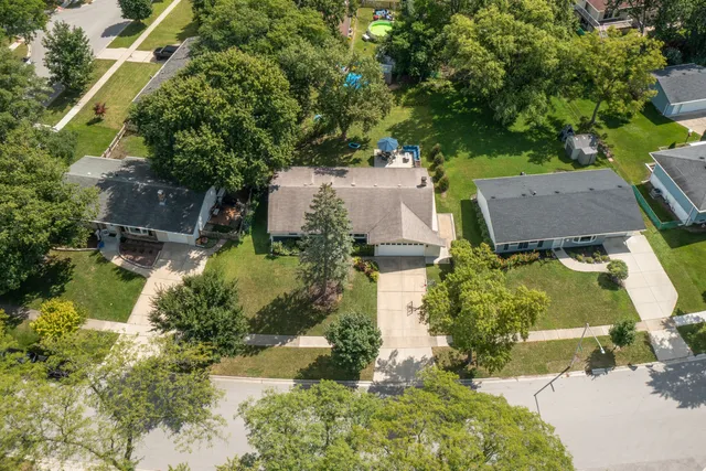 an aerial view of a house with a yard