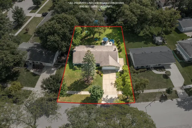 an aerial view of a house with a yard
