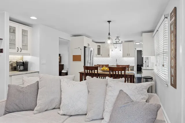a living room with furniture and a chandelier