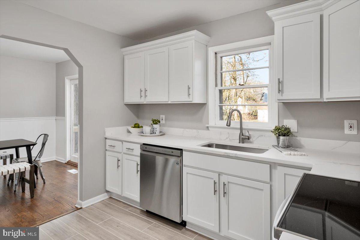 36 Carroll Road Pasadena, MD 21122 - Photo 12 of 37 a kitchen with a sink white cabinets and white appliances
