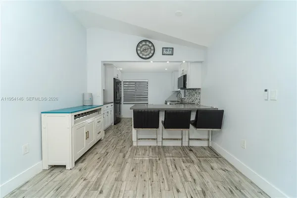 a kitchen with a table and a stove top oven