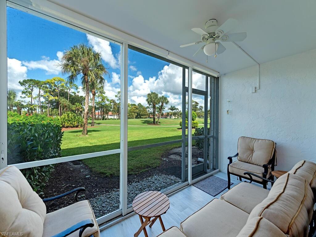 4556 Andover Way, Unit E104 Naples, FL 34112 - Photo 11 of 12 a outdoor living space with furniture and garden